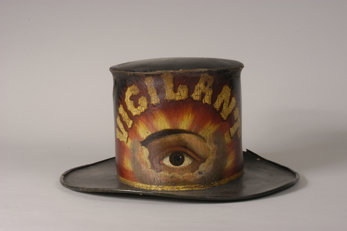 painted leather fire hat -- showing an eye in the clouds with the word vigilant in gold
