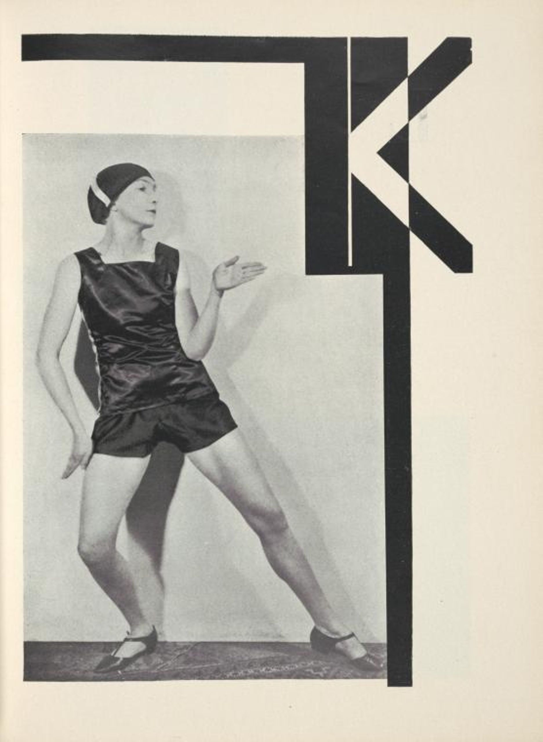 woman posing as a letter k next to the letter k